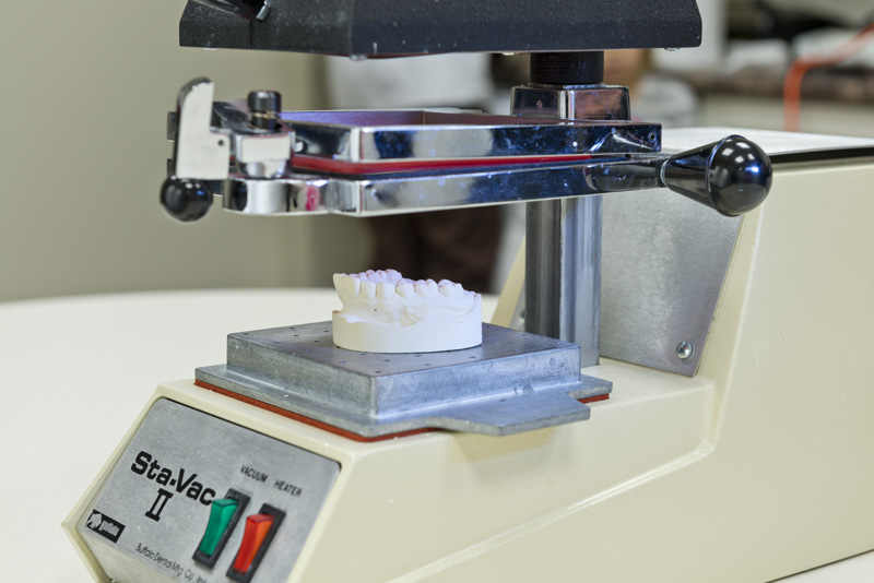 The model of your teeth is placed onto the tray of the Sta-Vac machine where the template of the mouthguard is placed as well